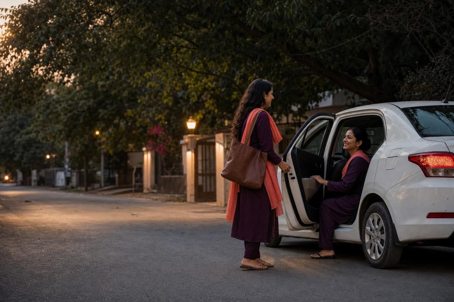 A woman driver welcoming a passenger into a white car at dusk